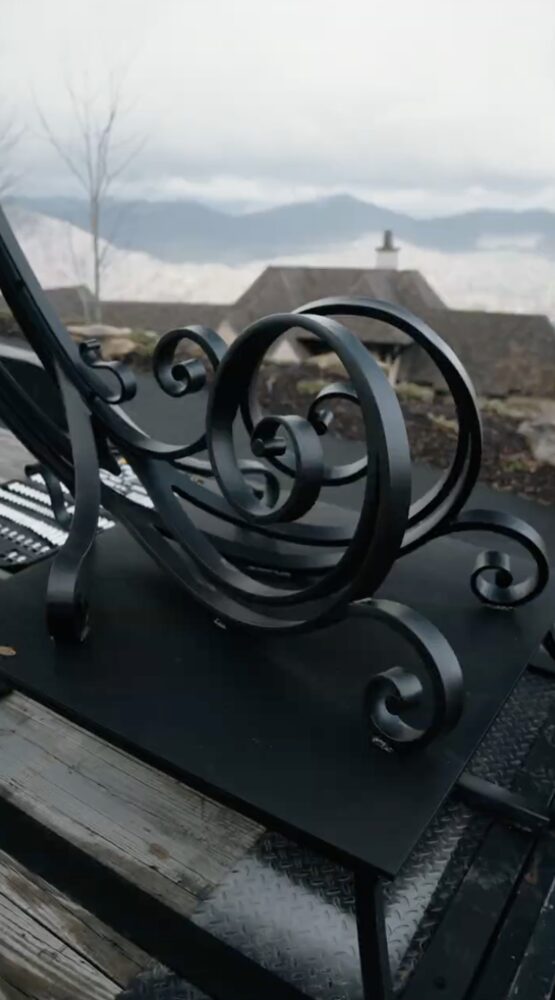 Custom solid-steel driveway arch forged by Heirloom blacksmith Josh Moore